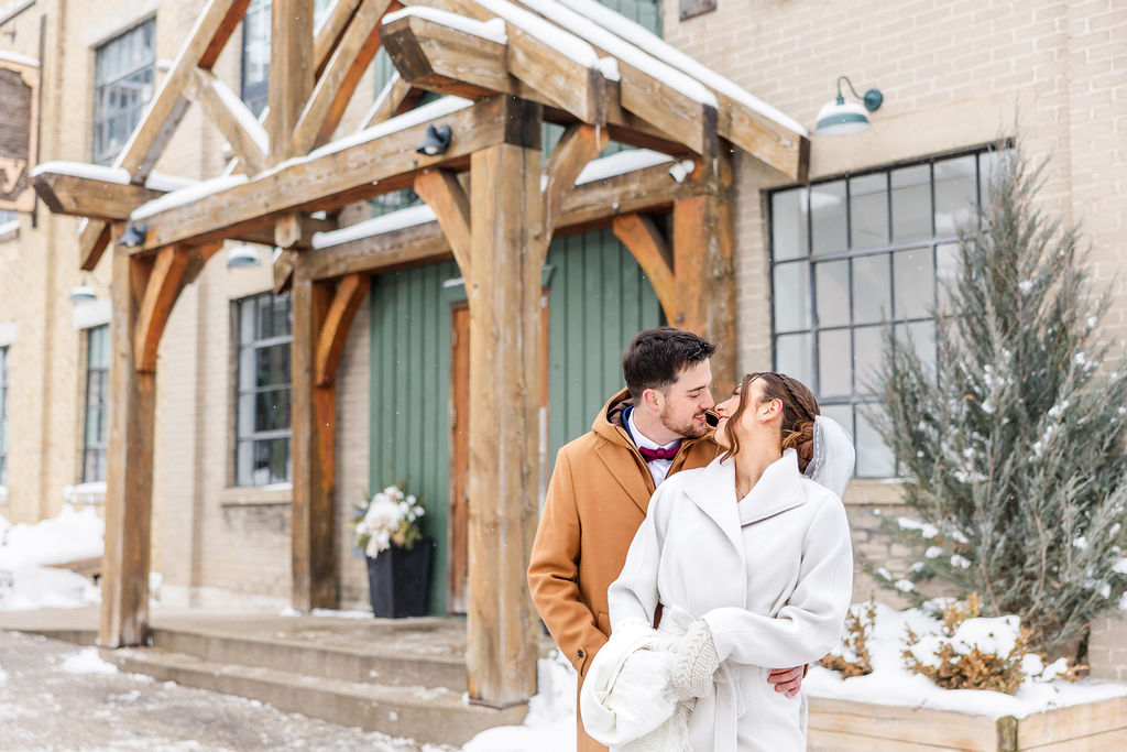 Timber Barn wedding. Couple Almost kissing in front of the venue